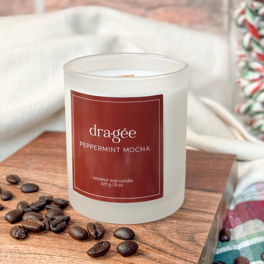 Peppermint Mocha Scented Candle Holiday Collection Holiday Candle with coffee beans and candy canes around the candle. White frost candle jar with copper red label.